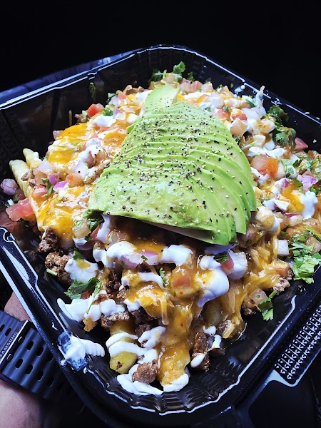 Loaded asada fries topped with avocado at Panza Verde