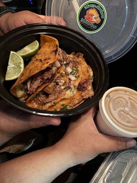Birria tacos held over consomé at Panza Verde