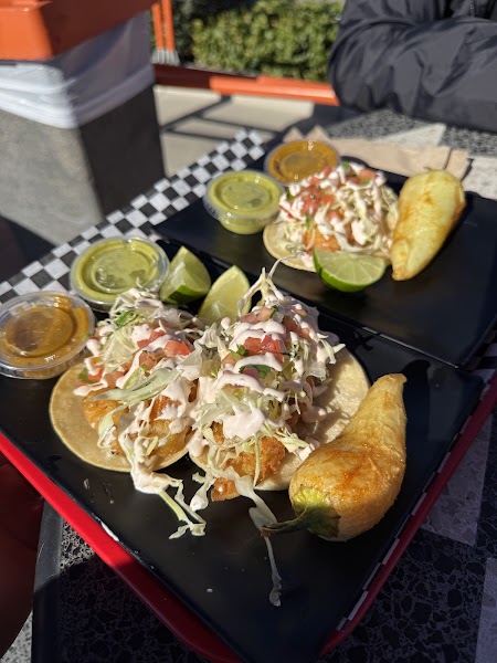 Battered fish tacos with cabbage and crema